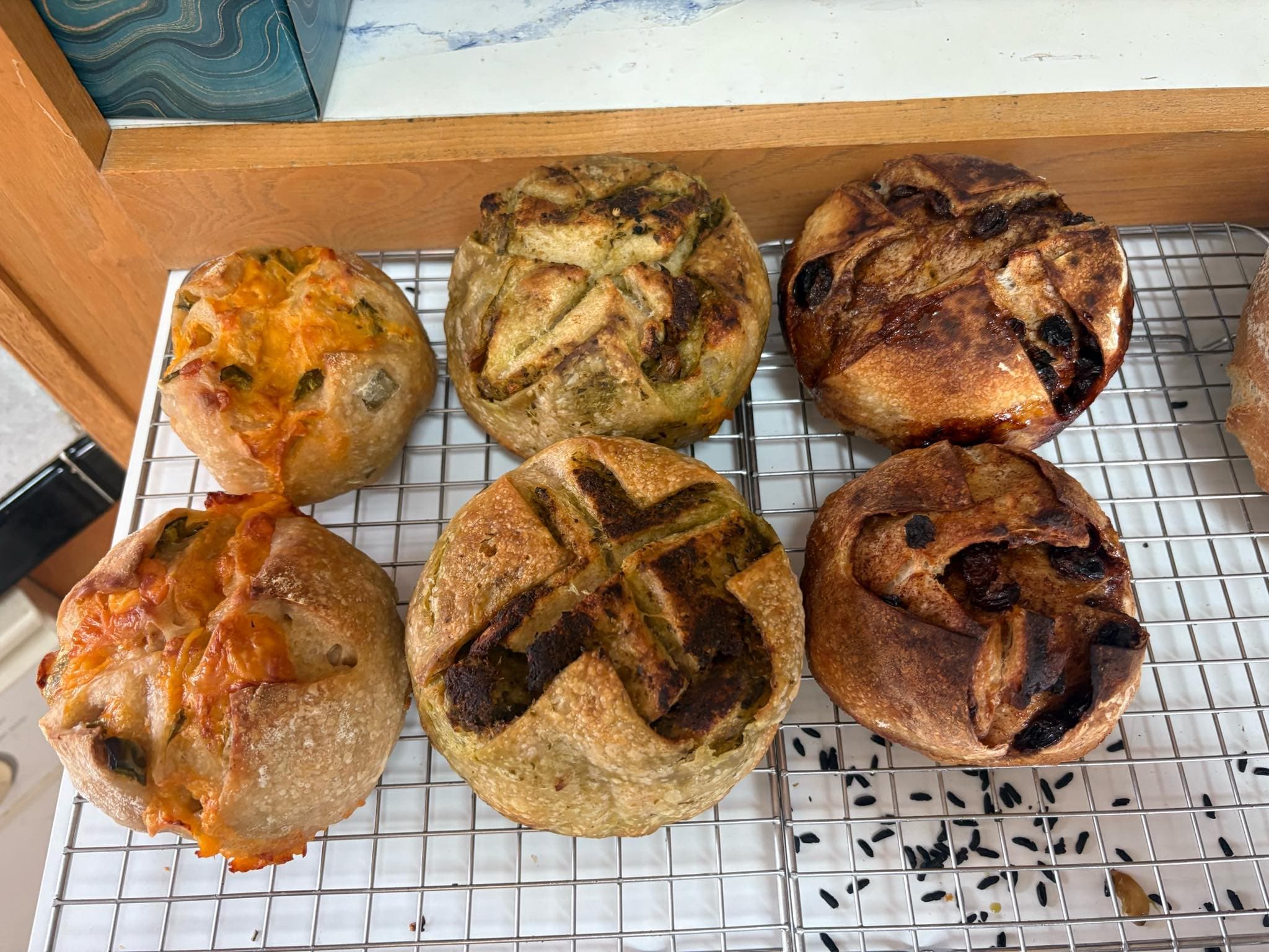 Freshly baked sourdough bread loaves cooling on a wire rack