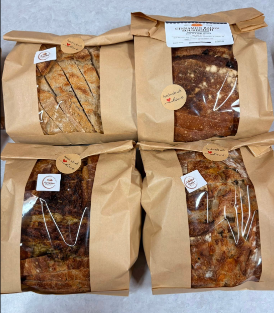 Sourdough bread loaves in craft paper packaging with handmade with love stickers