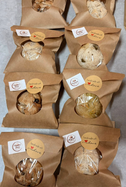 Assorted sourdough bread rolls in craft paper bags with handmade with love labels